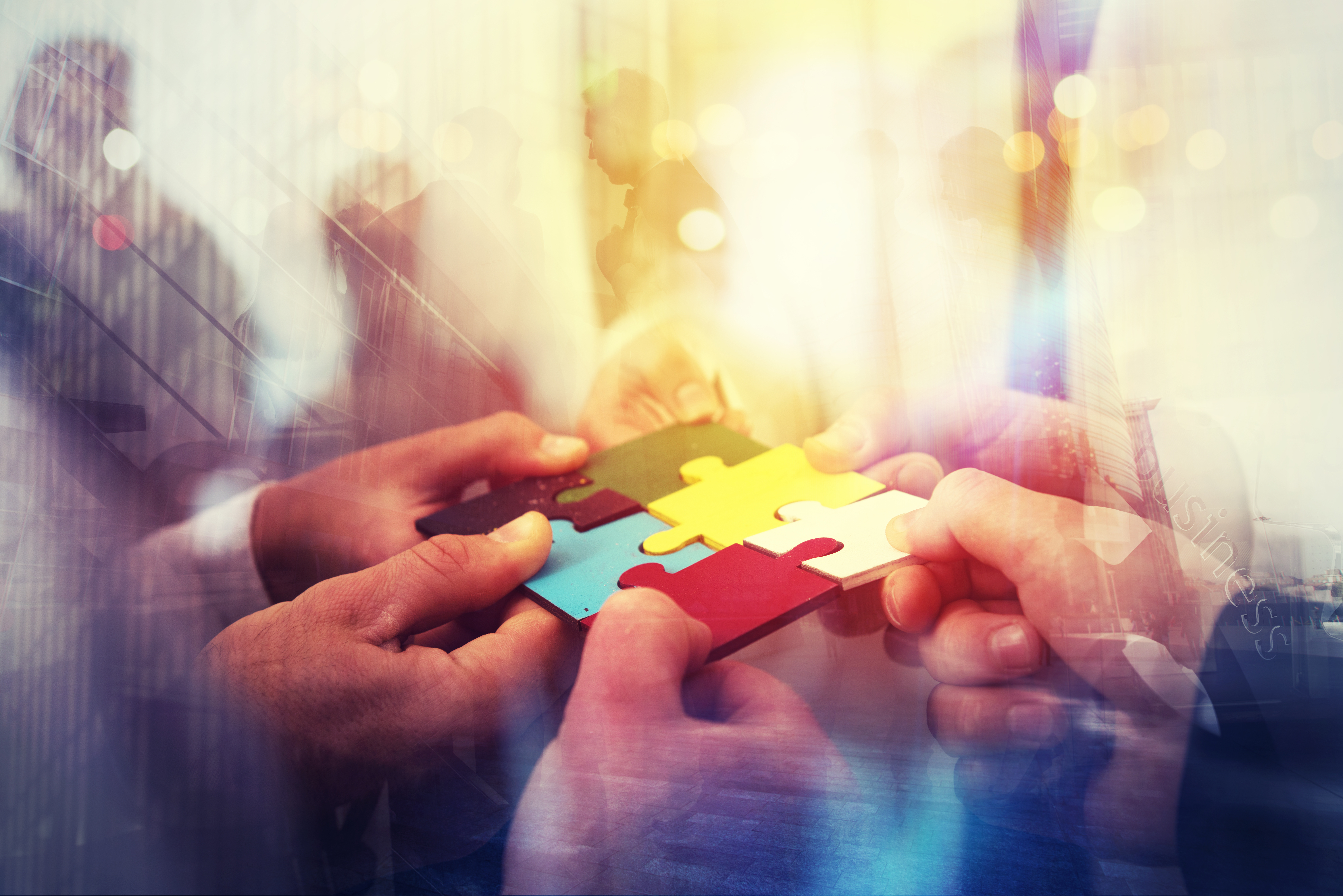 Business People Join Puzzle Pieces In Office. Concept Of Teamwork And Partnership. Double Exposure With Light Effects